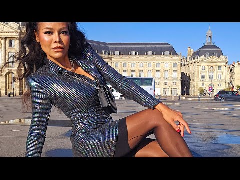 sequin long sleeves dress black stockings and hightheels shoes at the touristic place