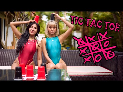 Two Cute Girls in One Piece Racing Swimsuit playing Tic Tac Toe