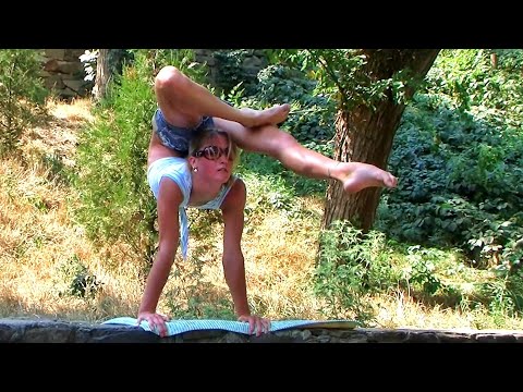Contortionist Julia doing handstand and backbend. Outdoor contortion. Flexshow.